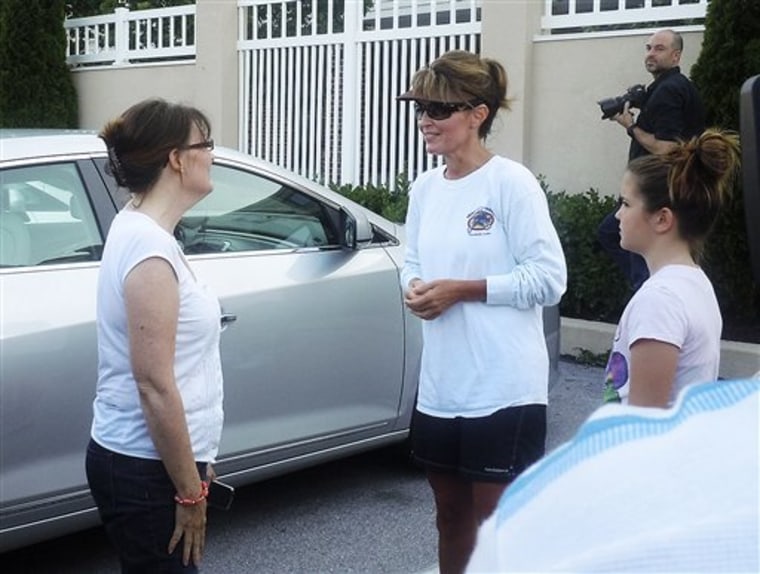 Sarah Palin, center, talks with fans at the front of the Courtyard Marriott at Gateway Gettysburg on Monday evening. Palin and her family began an East Coast tour in Washington on Sunday, renewing speculation that the former Alaska governor would join the still unsettled Republican presidential contest.